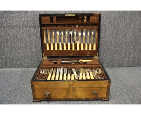 A vintage silver plated cutlery set in a walnut veneered case.