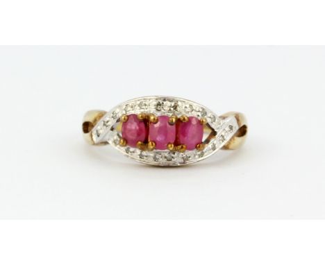 A 9ct yellow gold ring set with oval cut rubies and diamonds, (L).