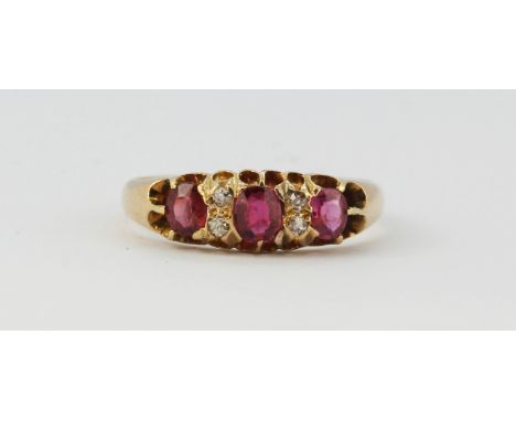 An early 20th century 18ct yellow gold ruby and diamond set ring, (L.5).