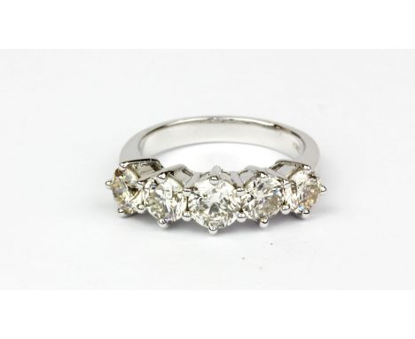 An18ct white gold (stamped 750) ring set with five brilliant cut diamonds, approx. 3.59ct, (N).