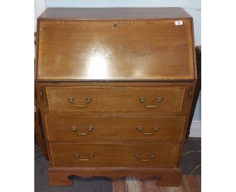 An Inlaid Edwardian Mahogany Bureau; with Satinwood Banding musical instrument and trailing floral detail, the fall front enc
