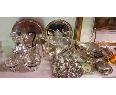 A Good Selection of Silver-Plate Items to include a three piece tea service, six eggcups on stand, toast rack, trays, etc.