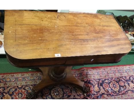 A Regency Mahogany D-End Foldover Card Table; raised on an octagonal vase shaped pillar and platform base with lions paw feet