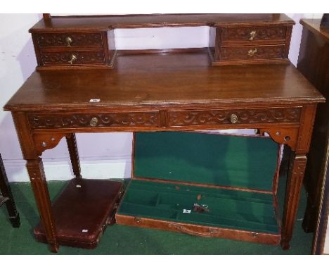 A Wonderful Late 19th Century Walnut Writing Desk; with highly carved front, gallery back with twin drawers under shelf, on s