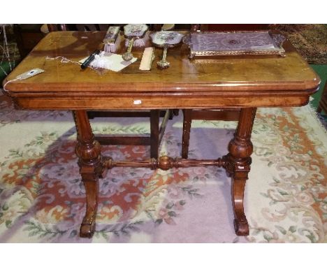A Victorian Walnut and String Inlaid Rectangular Foldover Top Card Table; with circular baize panel, raised on twin tapered f