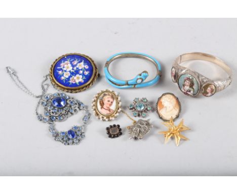 A silver and marcasite tortoise brooch, a Victorian white metal, blue enamel and moonstone snake bangle (damages), a Georgian
