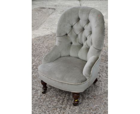 A 19th century low seat chair, button upholstered in a sage velour, on turned and castored supports 