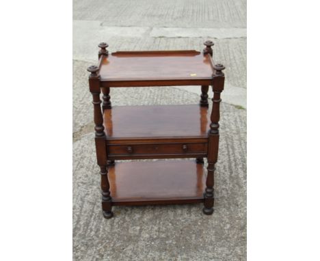 A late Victorian mahogany three-tier buffet/whatnot, fitted one drawer, on turned and castored supports, 24" wide x 16" deep 