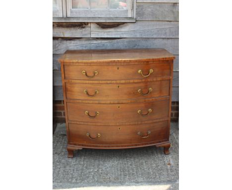 A 19th century mahogany bowfront chest of four long graduated drawers with brass swag handles, on ogee bracket feet, 38" wide