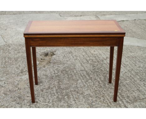 A 1960s sapele mahogany fold-over top card table, on square taper supports, 36" wide x 18" deep x 29" high 