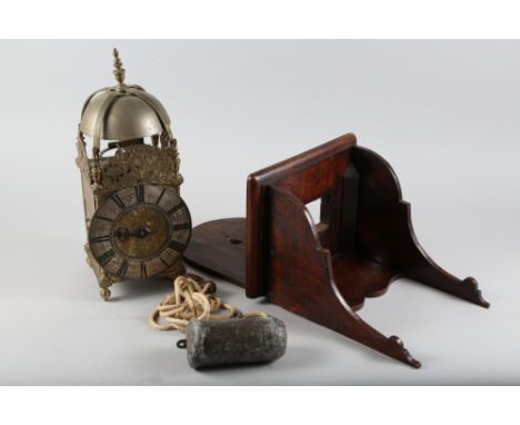 An early 18th century brass lantern clock with striking movement, engraved dial, silvered chapter ring and bob pendulum by Ro