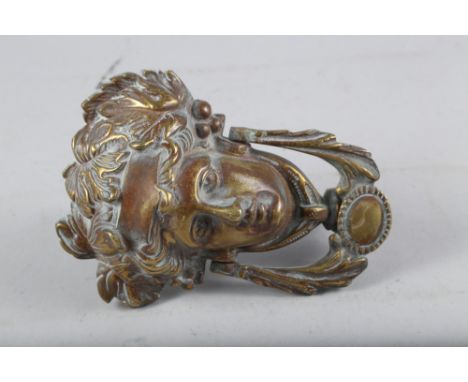 A cast brass female mask door knocker, 7" high 
