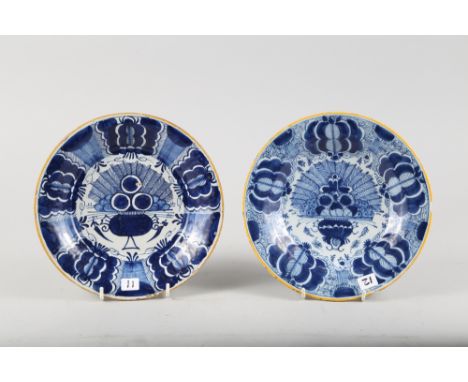 A pair of late 18th century Dutch delft "Peacock" pattern plates, 9" dia, one with "arrow" mark verso 