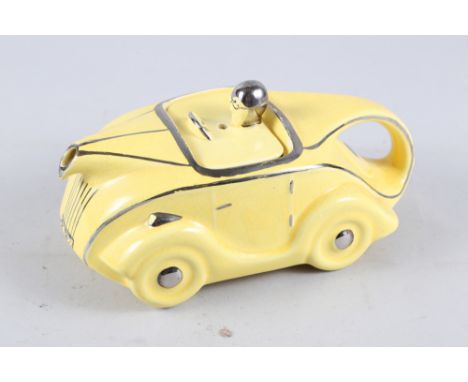 A 1930s Sadler yellow glazed sports car teapot, 9" long 