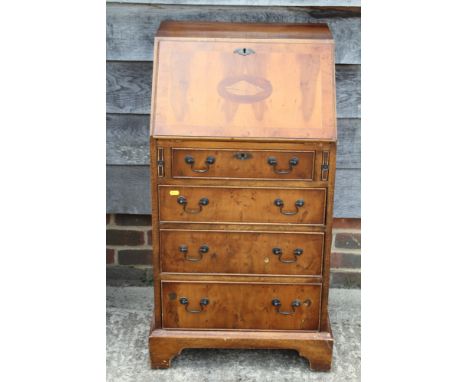 A yew banded and shell paterae inlaid fall front bureau, fitted four long drawers, on bracket feet, 22" wide x 19" deep x 38"