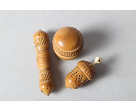 A 19th century turned tagua nut (vegetable ivory) and bone mounted thimble case, 2 1/4" long, a similar needle case, 3 1/2" l