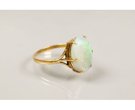 An oval opal ring set yellow metal stamped 18ct, size P