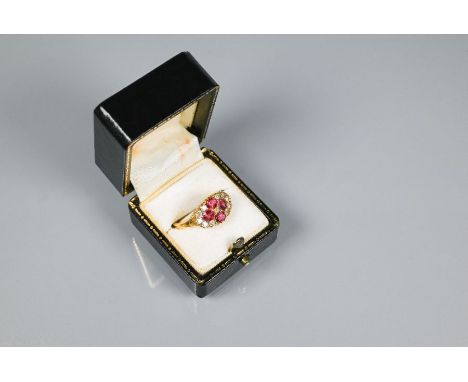 An antique ruby and diamond cluster ring formed of four circular rubies with eleven diamonds around, 18ct yellow gold set, si