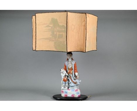 A Chinese table lamp with porcelain figure group of Guanyin with a small child painted in polychrome enamels standing on an o