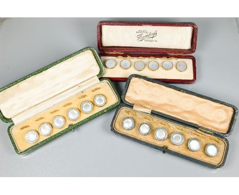 Three cased sets of mother-of-pearl round studs and clips - two sets with turquoise enamel borders, and one set with turquois