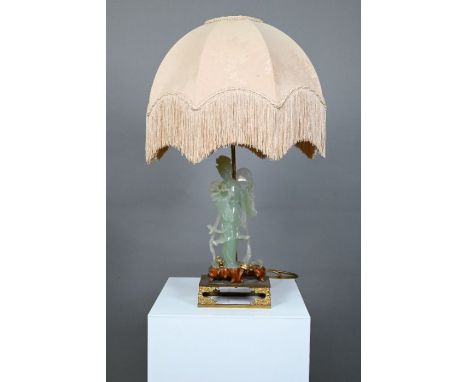 A Chinese bowenite gilt metal and hardwood lamp, the pale green stone figure carved as a courtesan holding a circular fan and