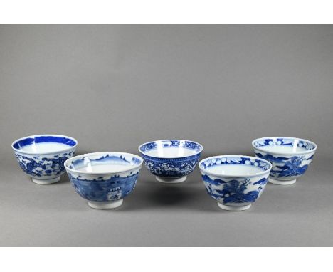 A pair of 19th century Chinese blue and white tea bowls painted in underglaze blue with a figure leading an ox over a bridge 