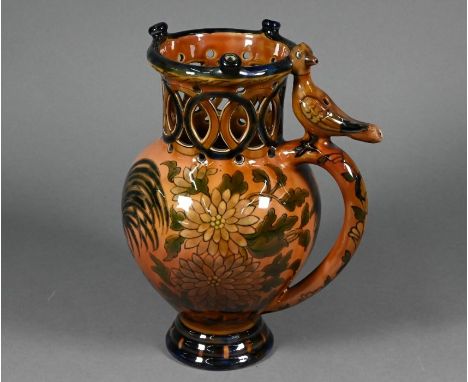 A Hungarian Zsolnay (Pecs) pottery puzzle-jug, painted with a cockerel among shrubbery, with pierced rim, the handle surmount