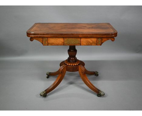 A Regency brass inlaid rosewood card table, the fold over swivel top raised on a moulded support to swept quad legs terminate