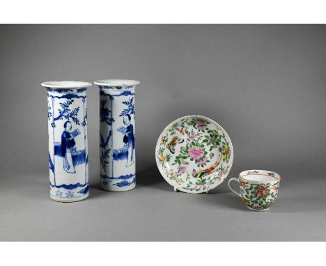 A pair of 19th century Chinese blue and white cylindrical vases with everted rims, painted with elegant ladies in fenced gard