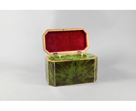 A Georgian green tortoiseshell tea caddy with canted corners, the hinged top enclosing two covered compartments with ivory ha