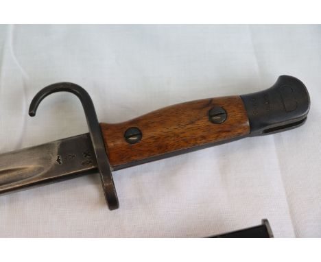 A British 1907 Pattern Bayonet with original scabbard, marked to the top of the blade with various marks to include 1907 & EF