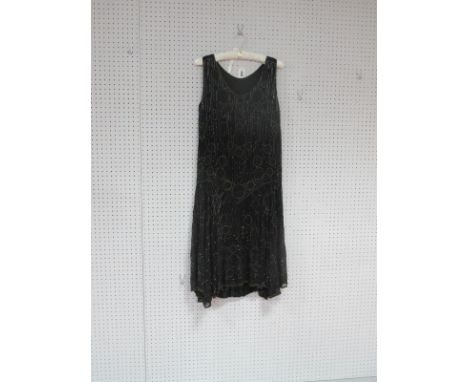 A Circa 1960's Vintage Flapper Style Dress, with dropped waist and side dipped hem, all-over beaded in black, gold and blue b