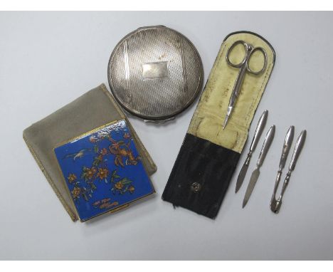 An Engine Turned Silver Compact, of circular form; one other, manicure set.