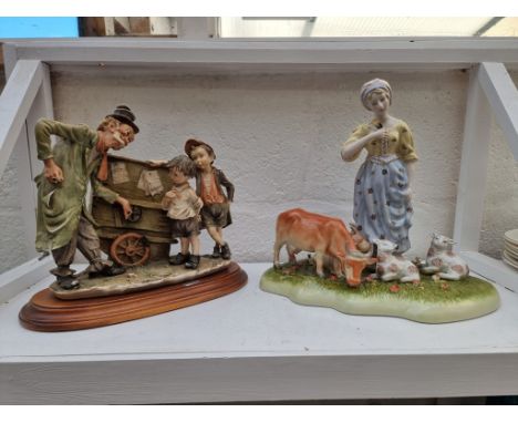 A Capodimonte figure group, on wood base, 29cm wide, (s.d.); together with a Continental porcelain figure group, 29cm high.