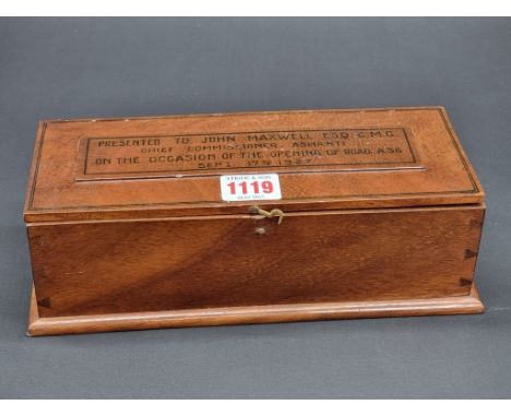 (SJM) A teak casket, the hinged cover inscribed 'Presented To John Maxwell Esq, C.M.G, Chief Commissioner, Ashanti, On The Oc