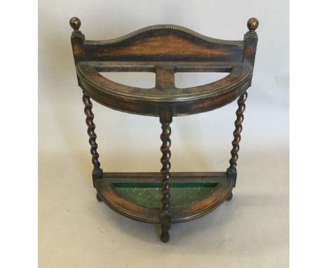 An early 20th century oak barley twist stick stand