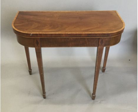 A 19th century mahogany fold over card table