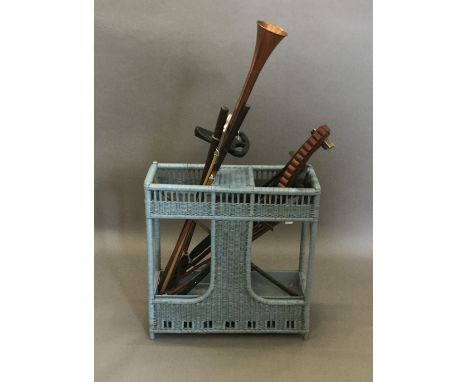 A stick stand containing various sticks, golf clubs, etc.