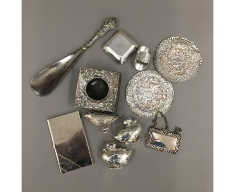 A silver patch box, a small silver frame, a pair of duck form salt and peppers and a small white metal bird, etc.