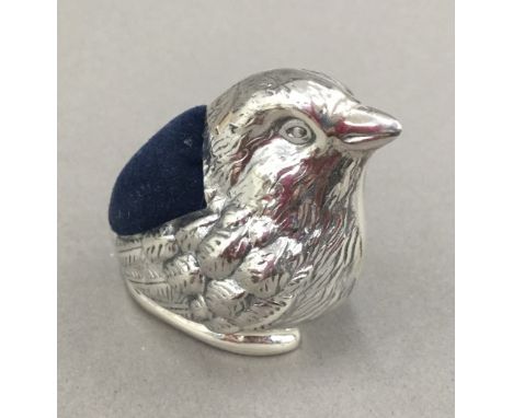 A silver pin cushion in the form of a bird