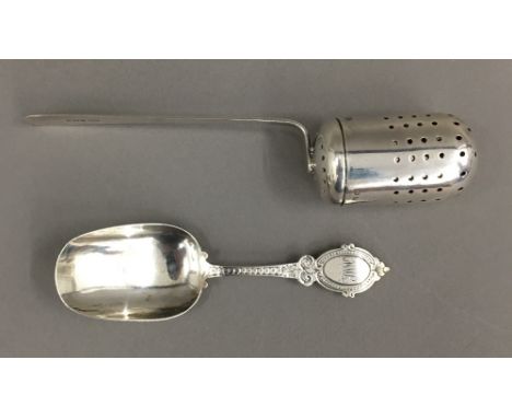 A silver infuser and a silver caddy spoon