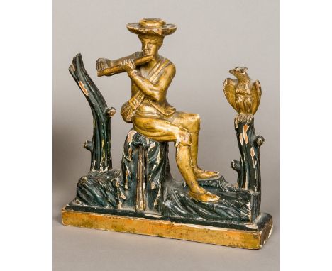 An 18th/19th century Continental carved giltwood and ebonised figure of a gentleman playing the flute, modelled seated on a t