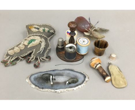 A small quantity of items, including a Victorian bead work pin cushion, a hard stone fruit, etc.