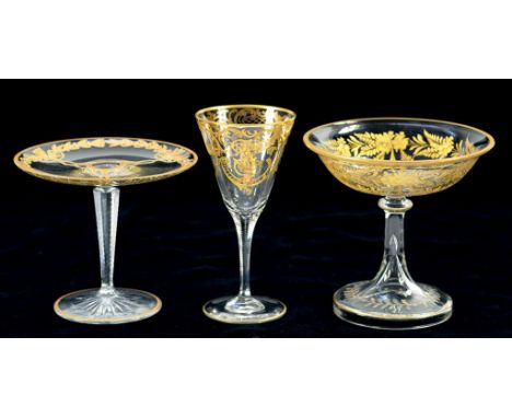 TWO GILT GLASS TAZZE AND A WINE GLASS, THE WINE GLASS WITH RAISED GILT MONOGRAM, 15.5CM H, EARLY 20TH CENTURY 