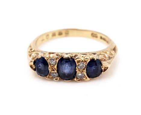 A sapphire and diamond ring, on 18ct yellow gold scrolling shank, ring size K, 4.1g gross. 