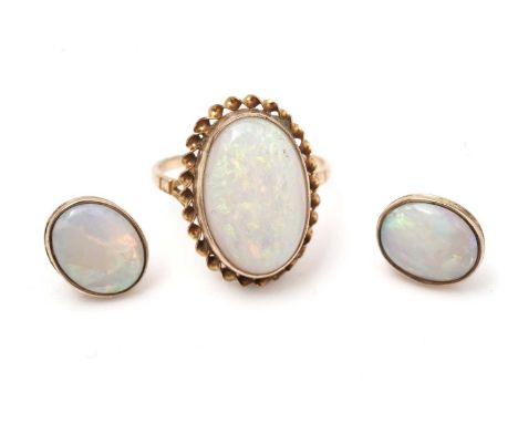 An opal cabochon ring, on 9ct yellow gold shank; and a pair of similar earrings, 5.5g gross.