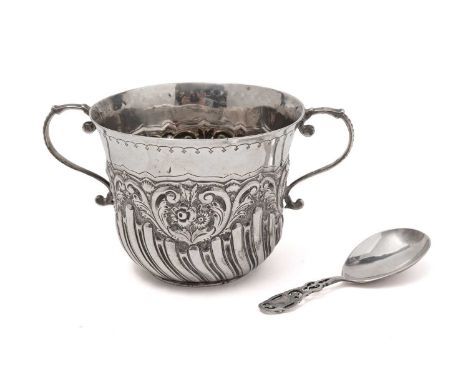 A silver porringer, by Josiah Williams &amp; Co, London 1898, with embossed floral and half fluted design; and a caddy spoon,