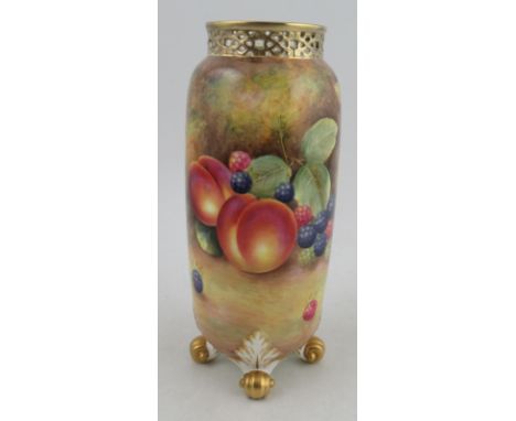 A Royal Worcester cylindrical vase, with pierced feet, decorated all round with fruit to a mossy background by Leaman, raised