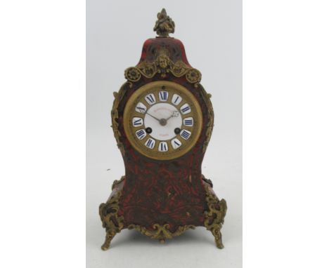 A Howell &amp; Co Paris, a French boulle decorated mantel clock, with gilet metal mounts and enamel to the dial, with strikin