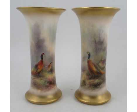A pair of Royal Worcester spill vases, decorated with pheasants in landscape by James Stinton, shape number G923, height 7.5i